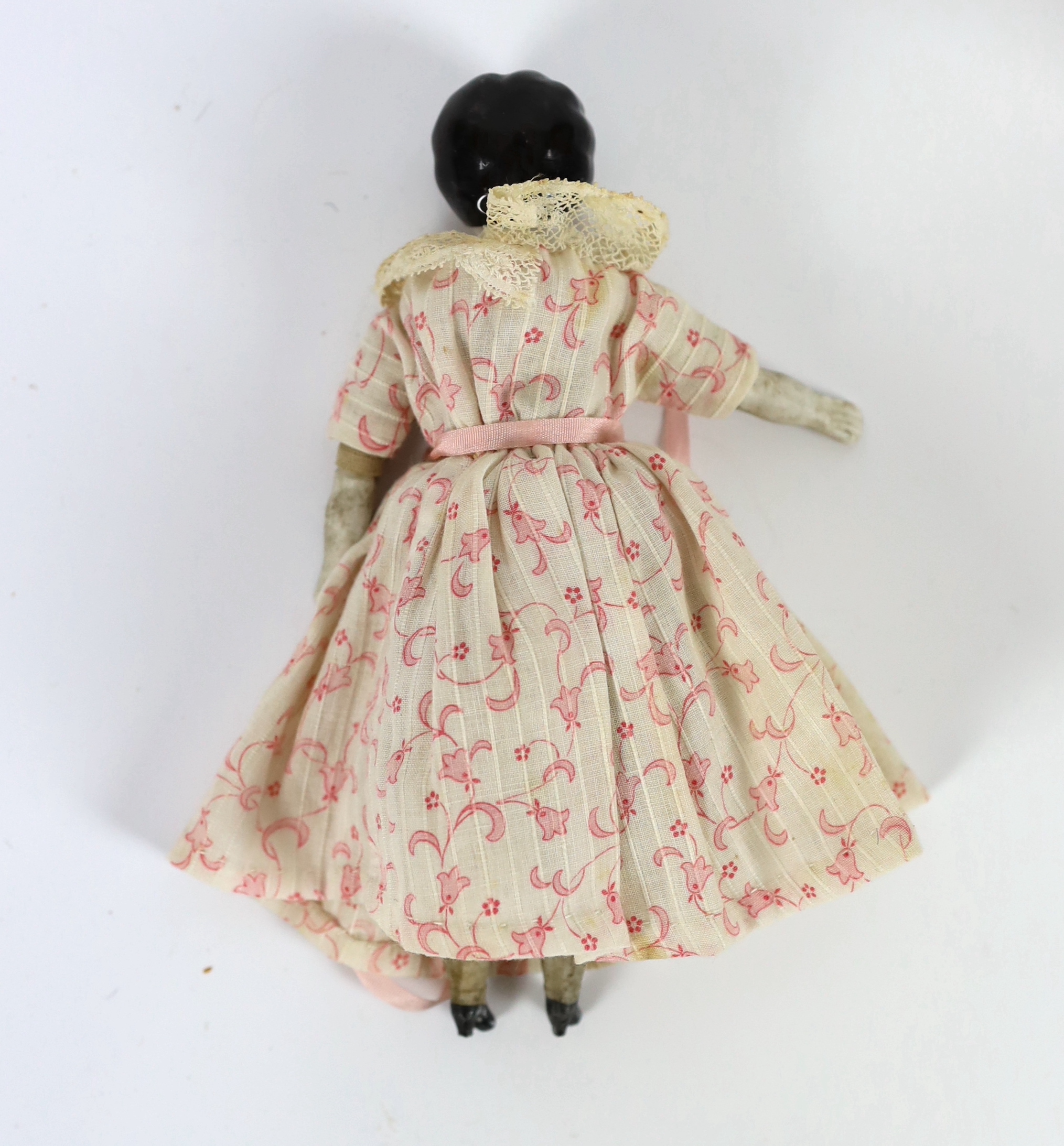 A composition fairy doll, c.1920m 15cm, with a china headed doll on soft body with bisque boots, c.1870, 15cm